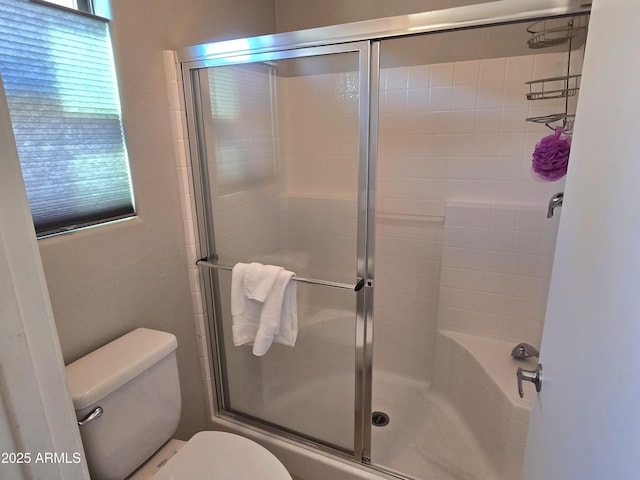 bathroom with toilet and a shower with shower door