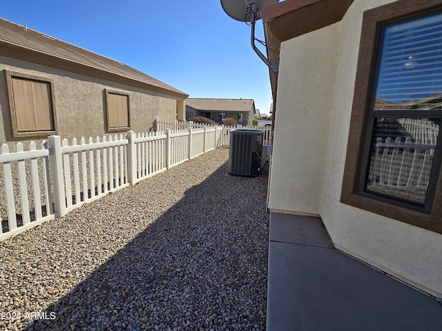 view of yard with central AC unit and a patio