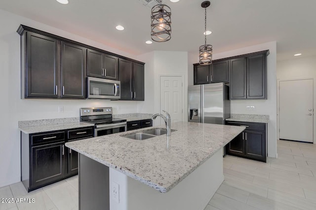 2254 E University Dr Unit 4, Mesa, AZ 85213 - kitchen with appliances with stainless steel finishes, light stone counters, recessed lighting, decorative light fixtures, and a kitchen island with sink