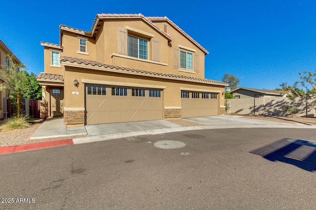 2254 E University Dr Unit 4, Mesa, AZ 85213 - view of front facade featuring stone siding, stucco siding, a tiled roof, and a garage