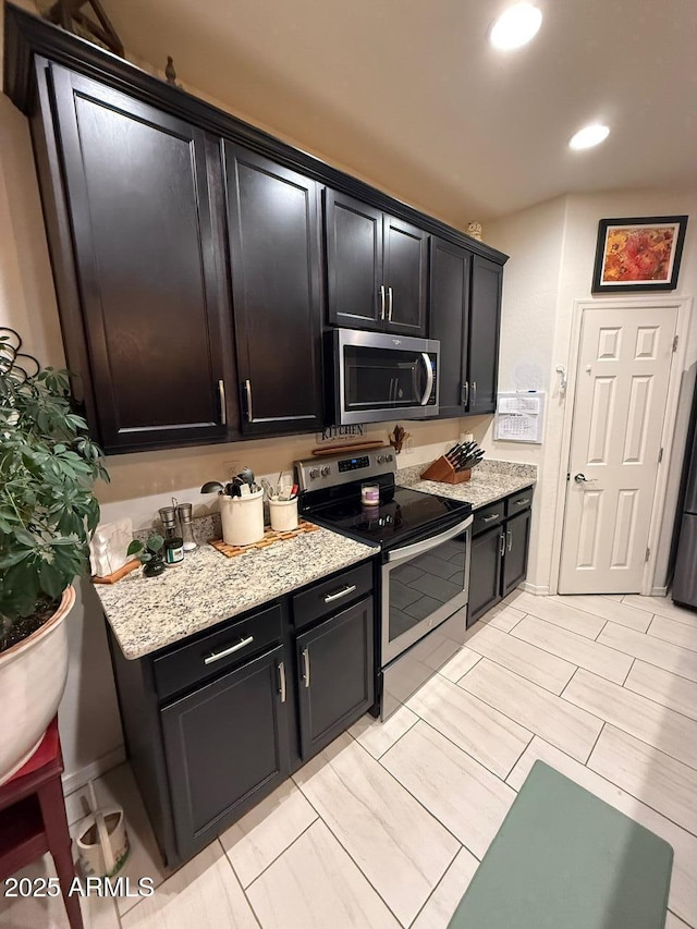 2254 E University Dr Unit 4, Mesa, AZ 85213 - kitchen with stainless steel appliances, dark cabinetry, recessed lighting, and light stone counters