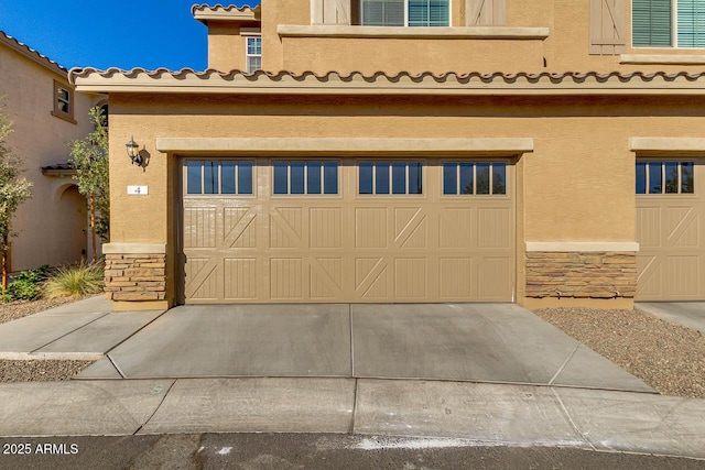 2254 E University Dr Unit 4, Mesa, AZ 85213 - view of front of property with stone siding, an attached garage, stucco siding, a tiled roof, and concrete driveway