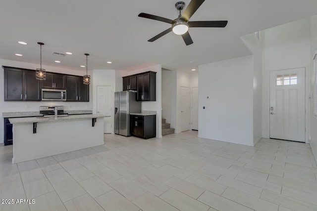 2254 E University Dr Unit 4, Mesa, AZ 85213 - kitchen featuring appliances with stainless steel finishes, a breakfast bar area, ceiling fan, recessed lighting, and open floor plan