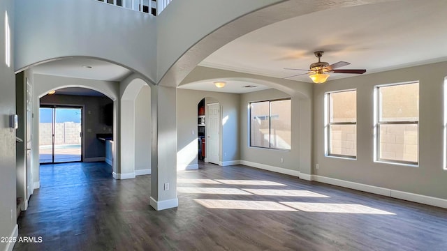 empty room with dark wood-type flooring and ceiling fan