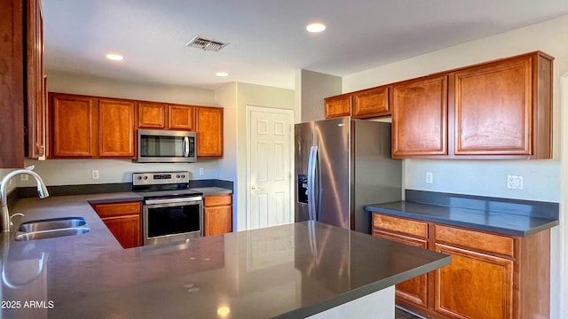 kitchen with stainless steel appliances, sink, and kitchen peninsula