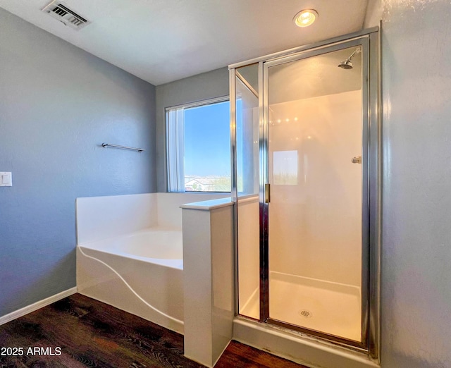 bathroom with hardwood / wood-style flooring and plus walk in shower