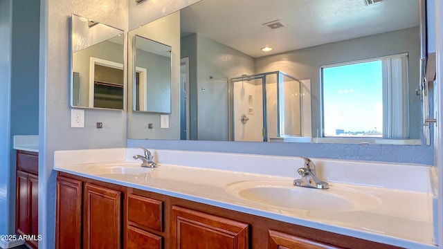 bathroom featuring vanity and a shower with shower door