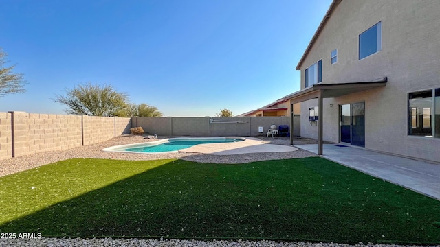 view of pool featuring a yard and a patio area