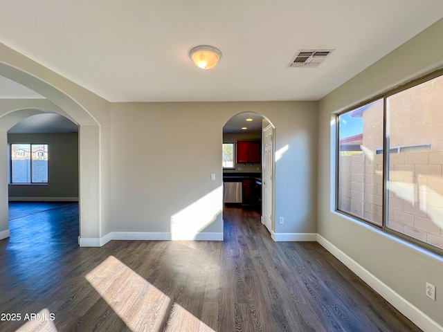 spare room with dark wood-type flooring