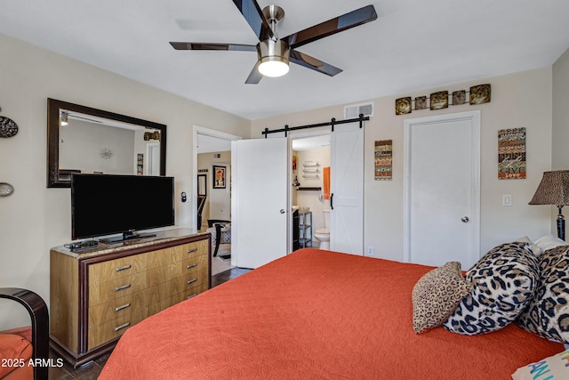 16624 E Palisades Blvd Unit 101, Fountain Hills, AZ 85268 - bedroom with a barn door, ceiling fan, visible vents, and ensuite bath