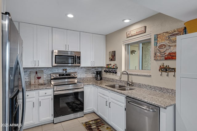 16624 E Palisades Blvd Unit 101, Fountain Hills, AZ 85268 - kitchen featuring light tile patterned flooring, a sink, white cabinetry, stainless steel appliances, and decorative backsplash