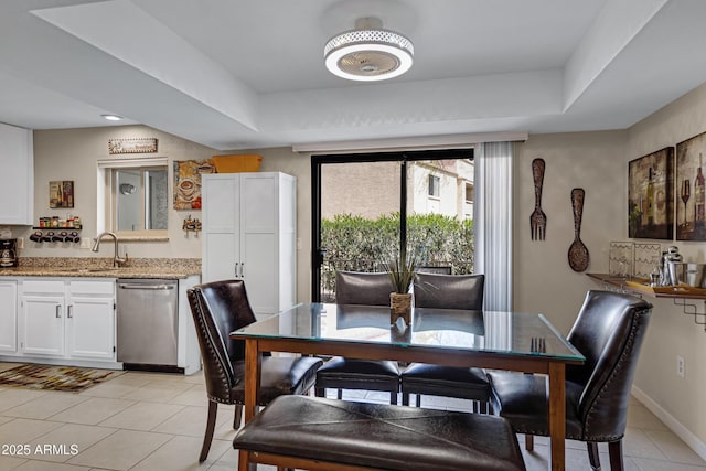 16624 E Palisades Blvd Unit 101, Fountain Hills, AZ 85268 - dining area with baseboards, a tray ceiling, and light tile patterned floors