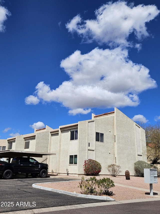 16624 E Palisades Blvd Unit 101, Fountain Hills, AZ 85268 - view of home's exterior featuring stucco siding and uncovered parking