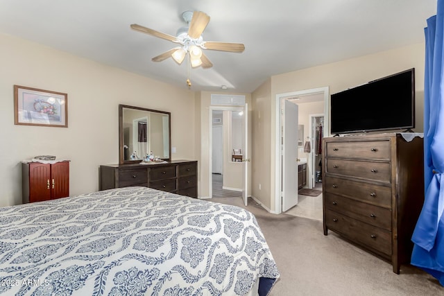 carpeted bedroom featuring ensuite bath and ceiling fan