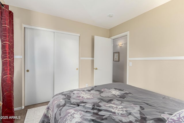 bedroom with light colored carpet and a closet