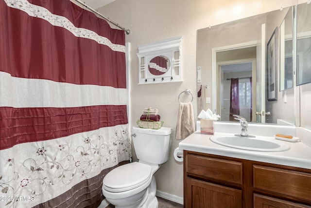 bathroom featuring a shower with shower curtain, vanity, and toilet