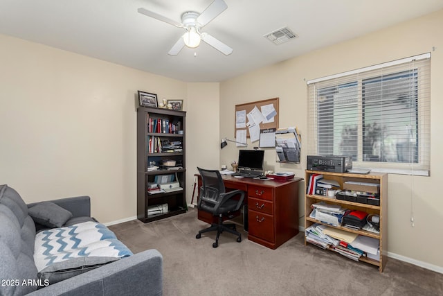 carpeted home office with ceiling fan