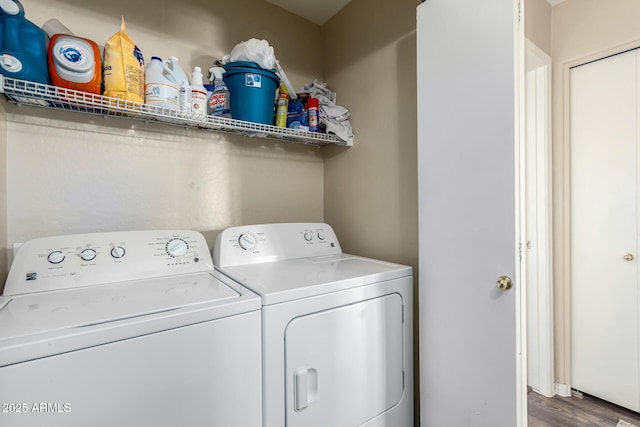 clothes washing area featuring hardwood / wood-style floors and independent washer and dryer