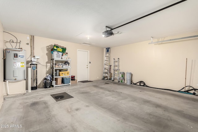 garage with water heater and a garage door opener