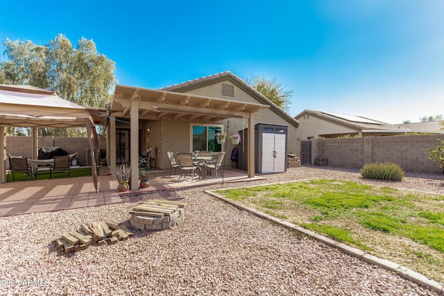 rear view of property with a pergola, a gazebo, and a patio area