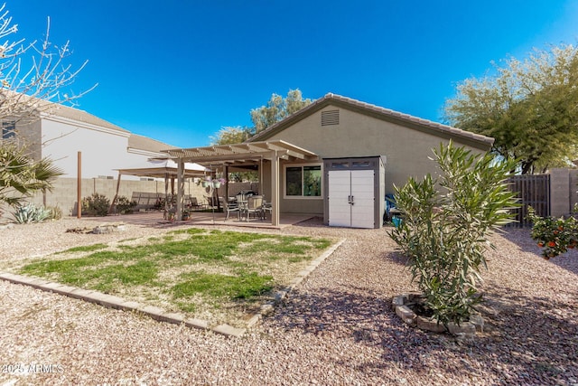 back of property with a pergola and a patio