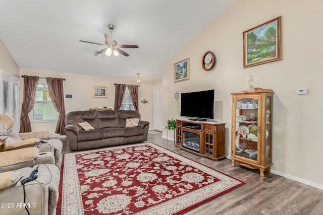 living room with ceiling fan, a healthy amount of sunlight, hardwood / wood-style floors, and lofted ceiling