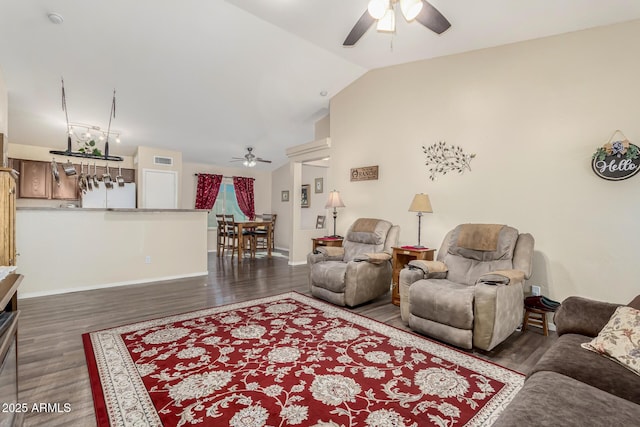 living room with ceiling fan, lofted ceiling, and dark hardwood / wood-style floors