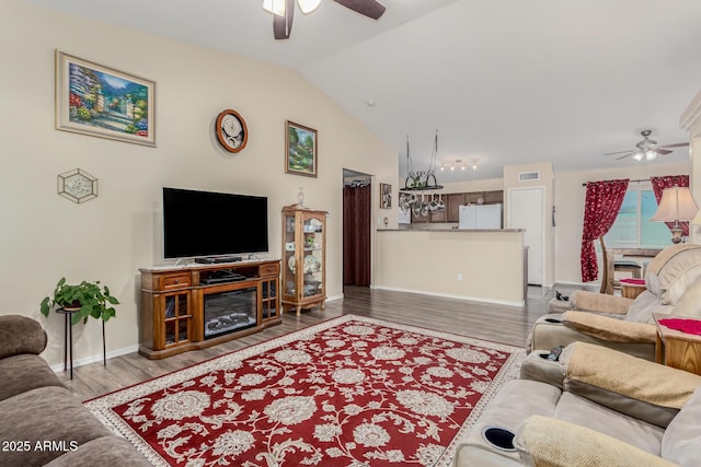 living room with lofted ceiling, ceiling fan, and wood-type flooring