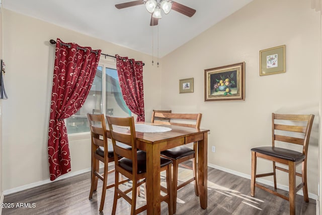 dining room with lofted ceiling, dark wood-type flooring, and ceiling fan