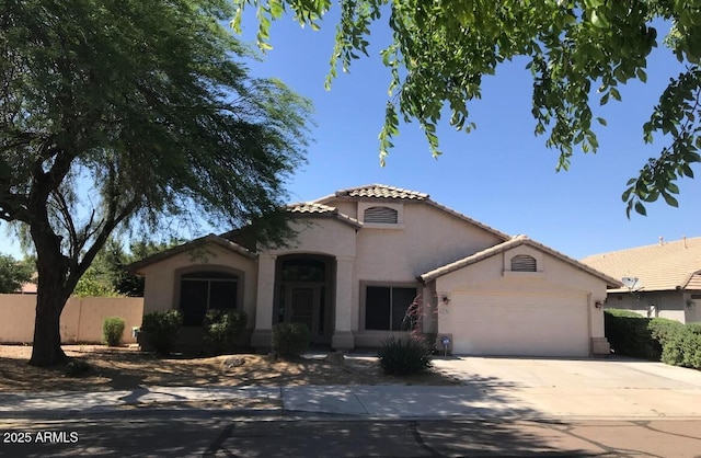 mediterranean / spanish home featuring a garage