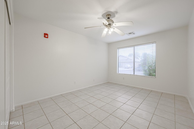 unfurnished room with ceiling fan and light tile patterned floors