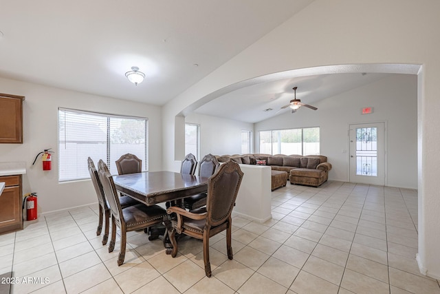 tiled dining area featuring ceiling fan and lofted ceiling