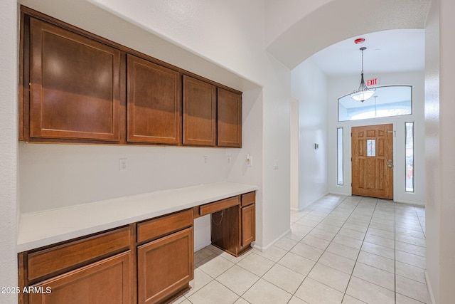 tiled foyer with built in desk