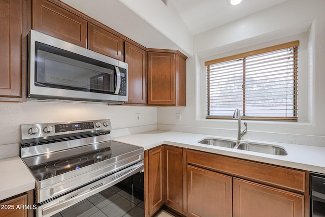 kitchen featuring sink, tile patterned floors, stainless steel appliances, and lofted ceiling