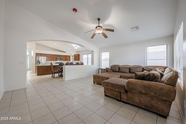 tiled living room featuring vaulted ceiling and ceiling fan