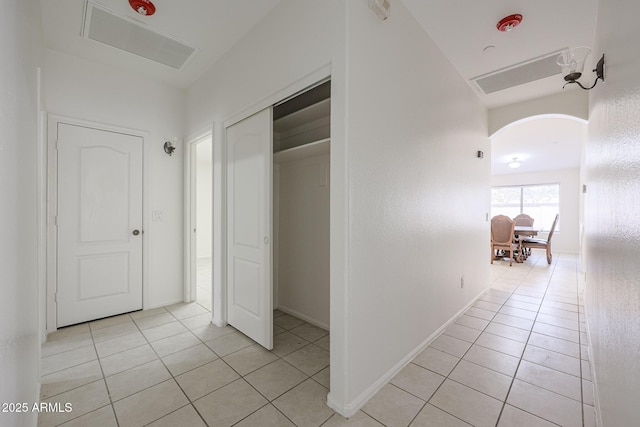 hall featuring light tile patterned floors