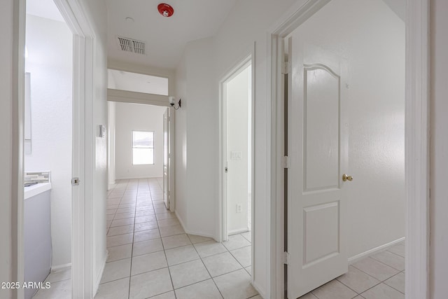 corridor with light tile patterned flooring