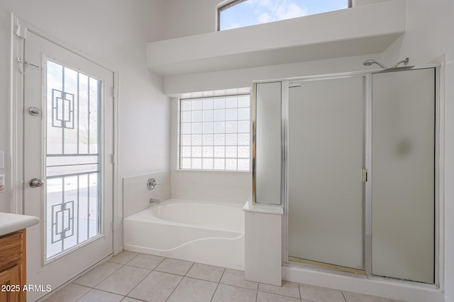 bathroom with separate shower and tub, vanity, and tile patterned floors