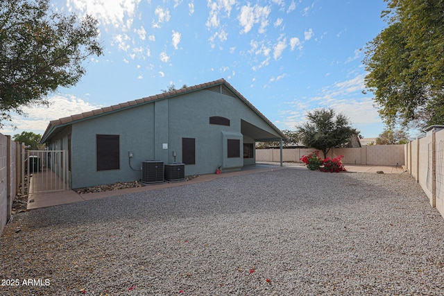 rear view of house with a patio area and cooling unit