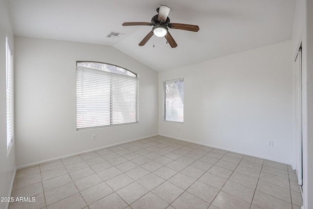 tiled spare room with vaulted ceiling, ceiling fan, and plenty of natural light