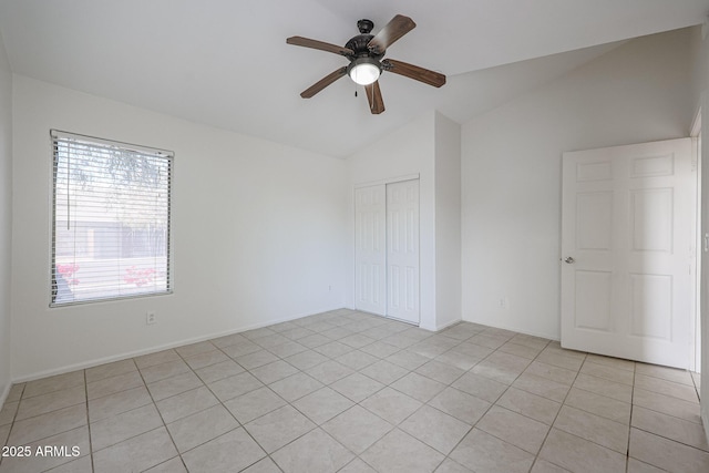 unfurnished room featuring vaulted ceiling, ceiling fan, and light tile patterned floors