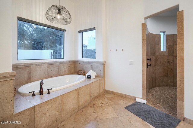 bathroom featuring tile patterned floors and separate shower and tub