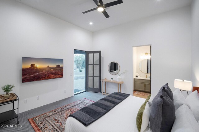 bedroom with access to outside, connected bathroom, light carpet, and ceiling fan