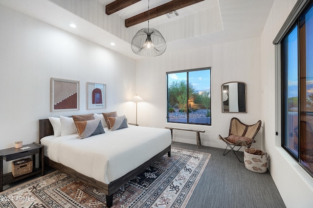 bedroom with dark carpet and beamed ceiling