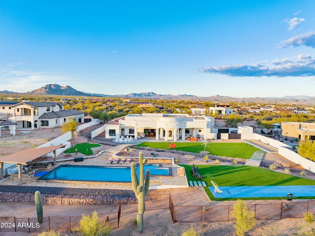 view of pool featuring a lawn, a patio, and a mountain view