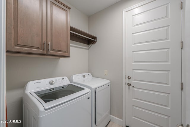 laundry area featuring cabinets and washing machine and clothes dryer