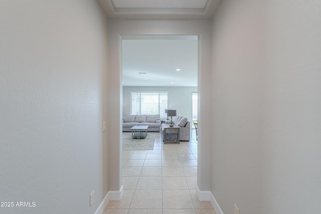 corridor featuring light tile patterned floors