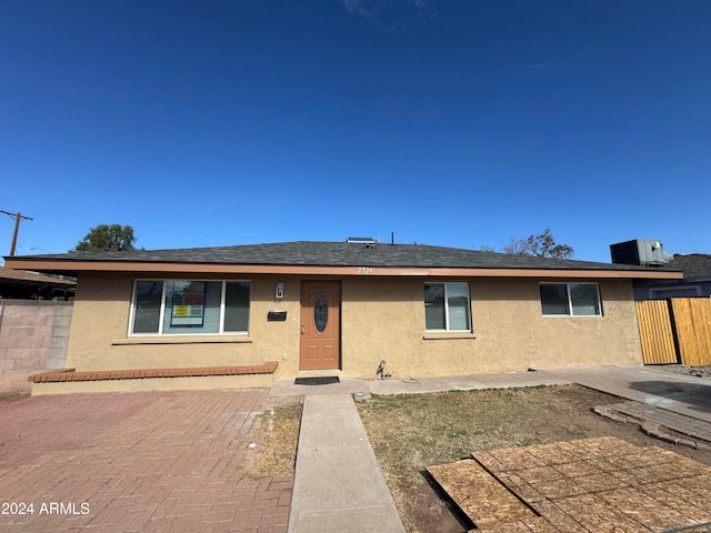 view of front of property featuring central air condition unit and a patio