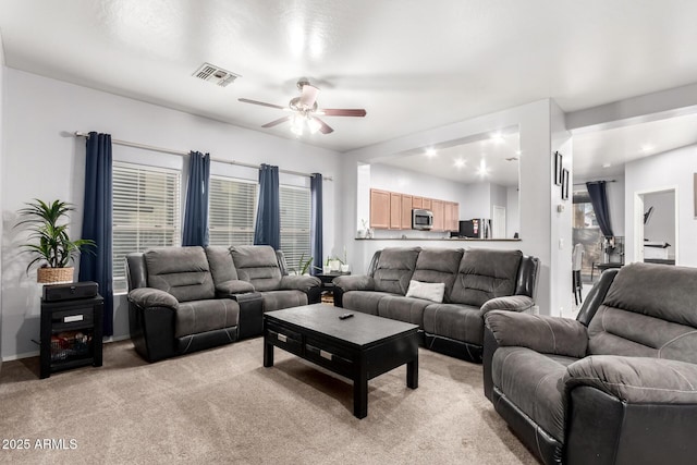 living room featuring light carpet and ceiling fan