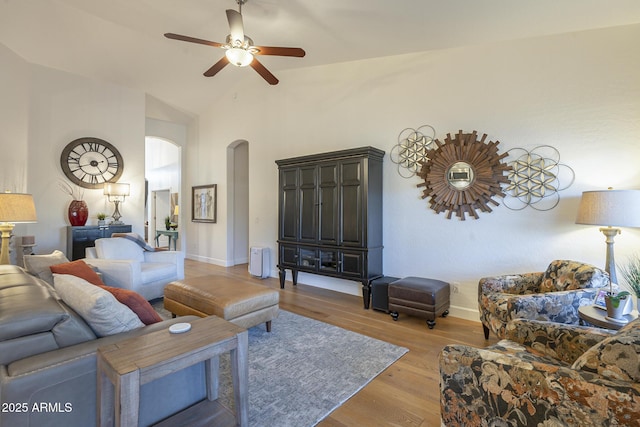 living room with ceiling fan, high vaulted ceiling, and light wood-type flooring